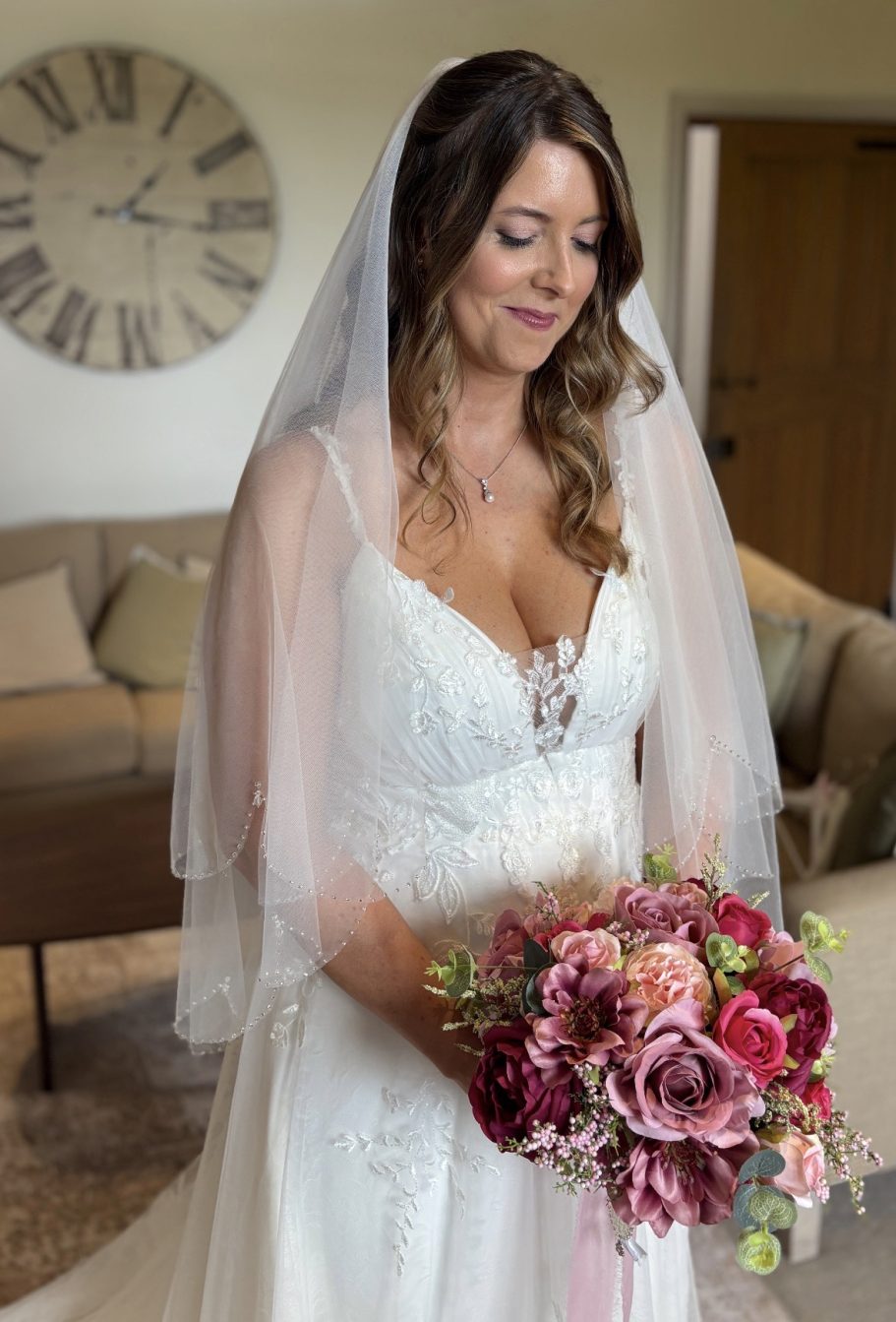 A bride with soft waved hair at Curradine Barns
